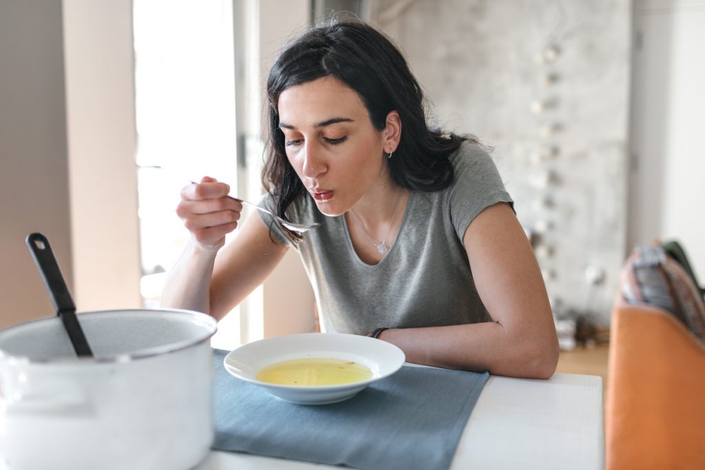young-woman-eating-soup